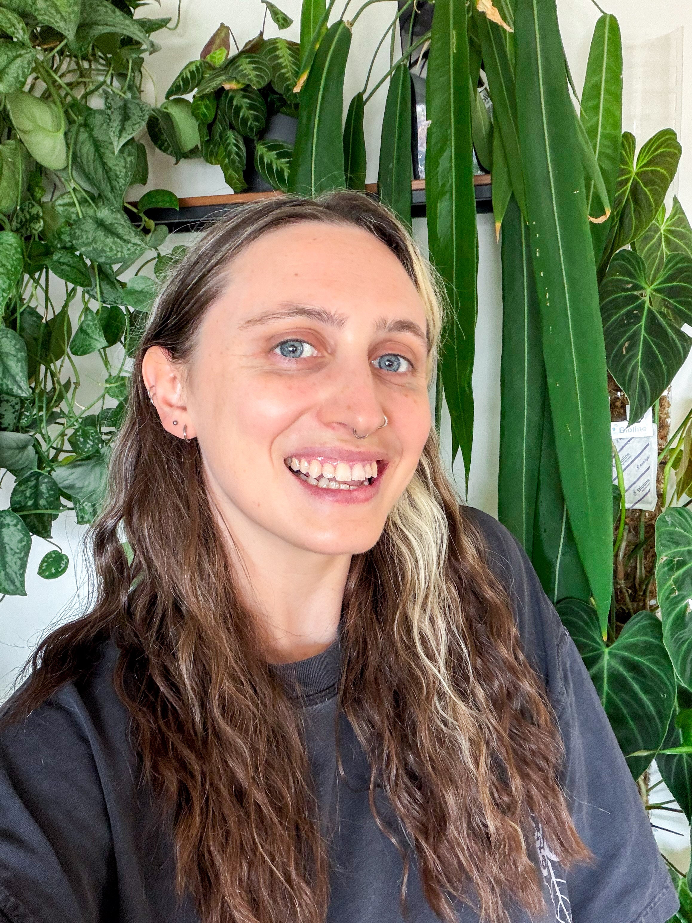 Plant With Lucy surrounded by houseplants